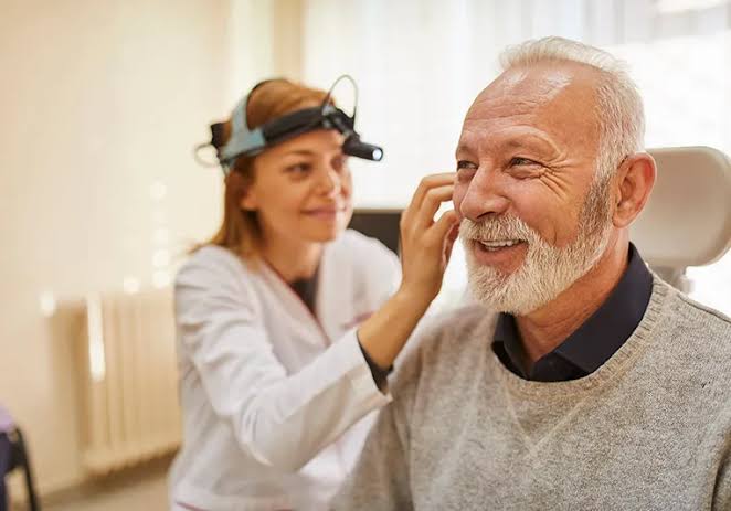 Audiologist with senior patient